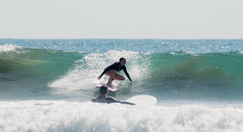 Surfer carving a turn off the wave